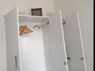 a closet with two white doors and shoes at Luxury Bayview Condo MOA & PICC Free WiFi in Manila