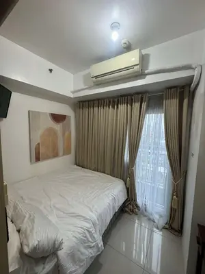 a bedroom with a bed with a air conditioner on the ceiling at Makati Jazz Staycation in Manila