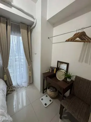 a bedroom with a desk and a chair and a window at Makati Jazz Staycation in Manila