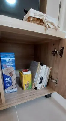 a shelf with books and a basket on it at Helaena's Scandi Haven in Manila
