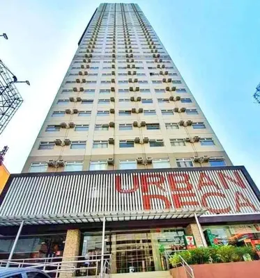 a tall building with balconies on the side of it at Dens condotel Metro Manila in Manila