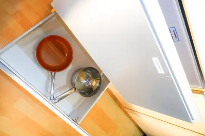 a trash can in a corner of a room at Studio in Makati - Fast WiFi, Big Balcony, Pool and Gym Access in Manila