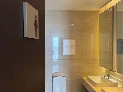 a bathroom with a sink and a toilet and a mirror at Studio in Makati - Fast WiFi, Big Balcony, Pool and Gym Access in Manila