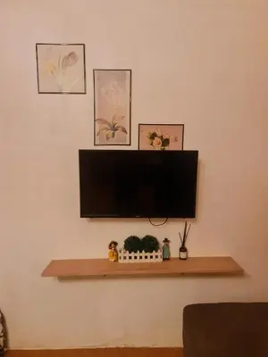 a flat screen tv sitting on top of a wall at Studio-type Home in Trece Martires near Tagaytay in Trece Martires