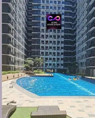 a large swimming pool in front of a large building at Mall of Asia Pasay Shore 3 residences 2 in Manila