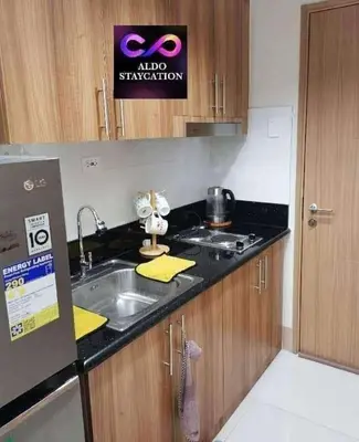 a kitchen with a sink and a counter top at Mall of Asia Pasay Shore 3 residences 2 in Manila