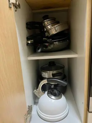 a cabinet with a tea pot and a tea kettle at Elegant Family Retreat in the Heart of BGC in Manila
