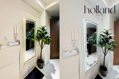 a bathroom with two mirrors and two potted plants at Mall of Asia Shore 3 Residences Holland Suites in Manila