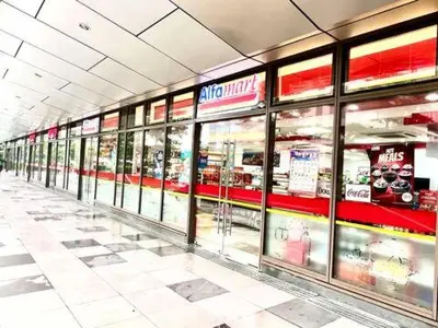 a store aisle of a grocery store with glass windows at Comfortable and Cozy 1BR unit near MOA in Manila
