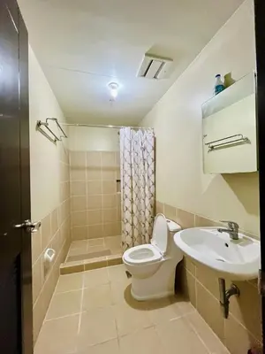 a bathroom with a toilet and a sink at Fully Furnished One Bedroom Unit with Balcony at Calathea Place, DMCI Homes in Manila