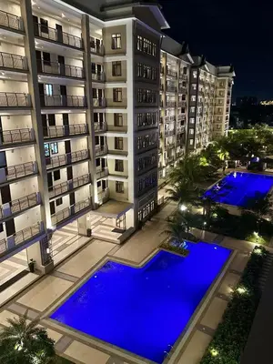 an aerial view of a building with two pools at Fully Furnished One Bedroom Unit with Balcony at Calathea Place, DMCI Homes in Manila