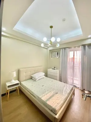 a bedroom with a large bed and a window at Fully Furnished One Bedroom Unit with Balcony at Calathea Place, DMCI Homes in Manila
