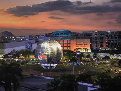 a large disco ball in a city at night at Mall of Asia Sea Residences AMY'S Staycation in Manila