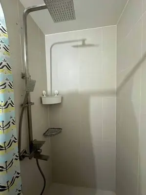 a shower with a glass door in a bathroom at Casita Payapa - newly furnished condo unit 2nd flr in Manila