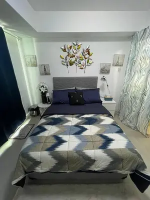 a bedroom with a large bed in a room at Casita Payapa - newly furnished condo unit 2nd flr in Manila