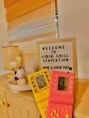 a remote control sitting on top of a counter with a sign at Vibin Chill Staycation in Manila