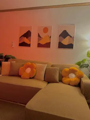 two stuffed animals sitting on a couch in a living room at Vibin Chill Staycation in Manila