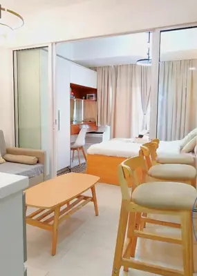 a bedroom with a bed and a living room at Casa Marix & Z - City View Unit in Manila