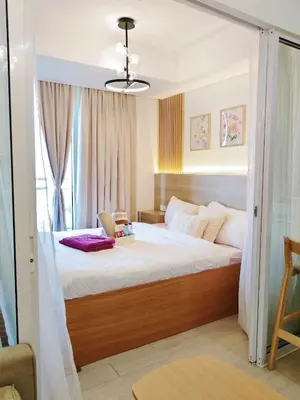 a bedroom with a canopy bed with a window at Casa Marix & Z - City View Unit in Manila