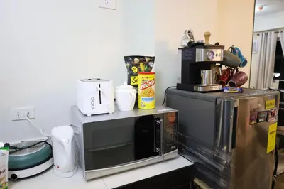a microwave oven sitting on top of a counter at Sojourner's Suite at 605, City-view condotel near the airport at Monte Carlo Residences Charlene in Manila