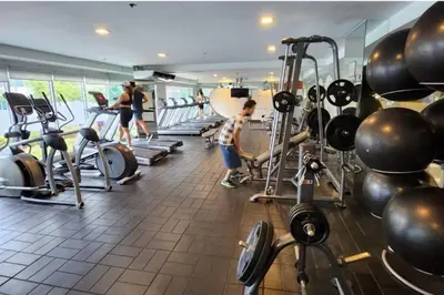 a group of people in a gym with weights at Boho Beach Vibes 2br Apt 2 in Makati in Manila