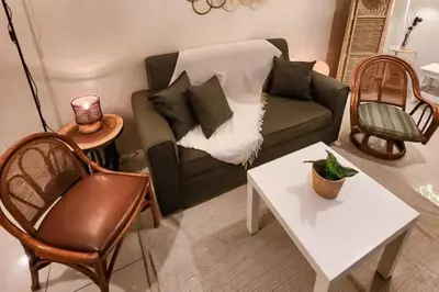 a living room with a couch and a table at Boho Beach Vibes 2br Apt 2 in Makati in Manila