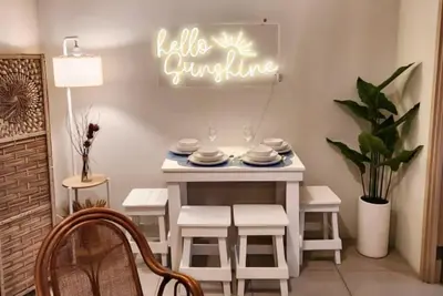 a dining table with chairs and a sign that reads table culture at Boho Beach Vibes 2br Apt 2 in Makati in Manila