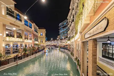 a canal in the middle of a shopping mall at night at Casa Feliza Belle-veranda overlooking Venice Grand Canal Gondola ride, with pool,gym,tennis,basketball courts,sauna and massage room in Manila