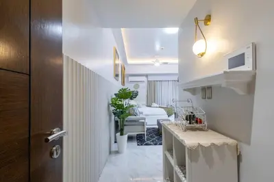 a room with a hallway with a living room at Casa Feliza Belle-veranda overlooking Venice Grand Canal Gondola ride, with pool,gym,tennis,basketball courts,sauna and massage room in Manila