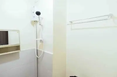 a shower in a white bathroom with a shower at Urban Deca Tower OYO in Manila