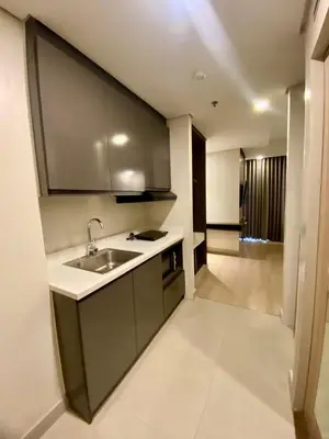 a kitchen with a sink and a counter top at The Metro Nest at Bonifacio Civic Center Tower in Manila