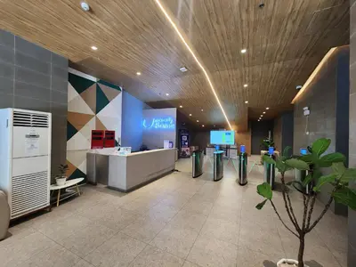an office with a lobby with a reception desk and a tree at UHome Lacson in Manila