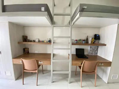 a room with a desk and a loft bed at UHome Lacson in Manila