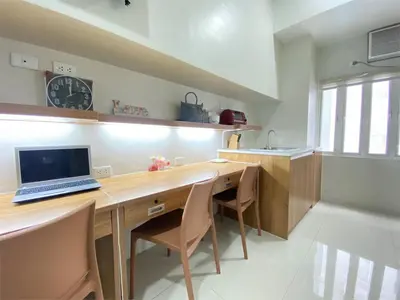 a kitchen with a desk with a laptop on it at UHome Lacson in Manila