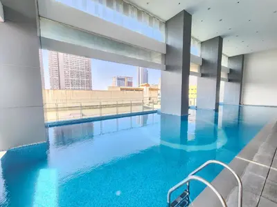a swimming pool in a building with a view at UHome Lacson in Manila
