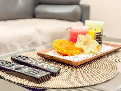 a table with a tray of food and a remote control at 826 Air Condo Comfort Suite Spacious 1BR in Manila