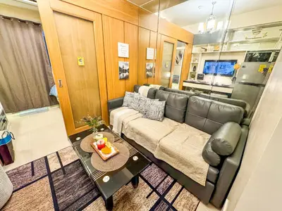 a living room with a couch and a table at 826 Air Condo Comfort Suite Spacious 1BR in Manila