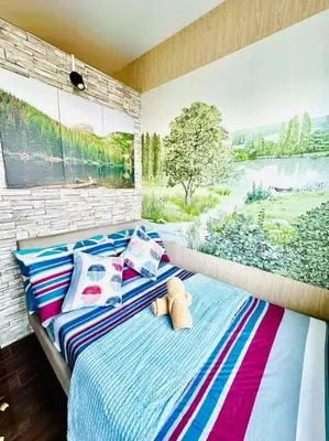 a bedroom with a bed with a large window at Classy Modern Haven 1BR Air Residence Makati in Manila