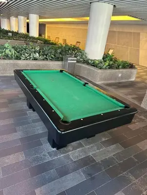 a green pool table sitting in a building at Classy Modern Haven 1BR Air Residence Makati in Manila