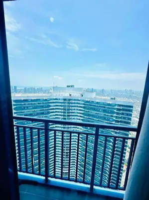a view of a large building from a balcony at Classy Modern Haven 1BR Air Residence Makati in Manila