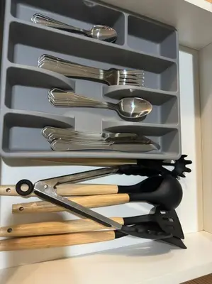 a drawer filled with cooking utensils in a drawer at Cozi Chic 1br Condo beside One uptown Mall BGC in Manila