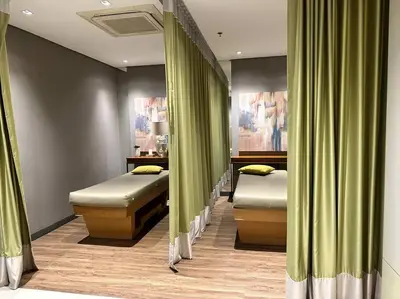 two beds in a room with green curtains at Cozi Chic 1br Condo beside One uptown Mall BGC in Manila