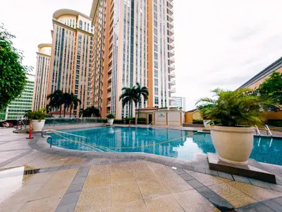 a swimming pool in a city with tall buildings at COZI Venice Luxury Residences Mckinley BGC with Pool in Manila