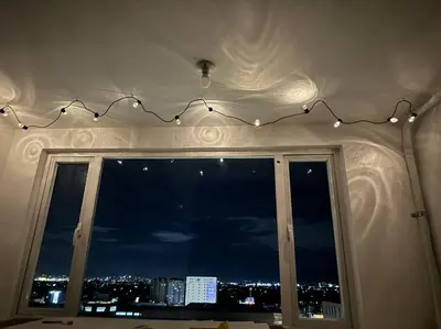 a window with a view of a city at night at Las Pinas City Cozy Escape in Manila
