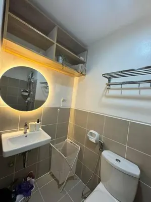 a bathroom with a toilet and a sink at Las Pinas City Cozy Escape in Manila
