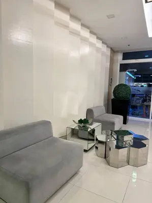a living room with a couch and a table at Las Pinas City Cozy Escape in Manila
