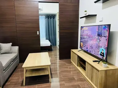 a living room with a video game on the tv at 1 Bedroom Condo in Makati City in Manila