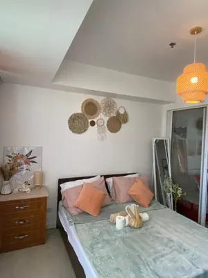 a bedroom with a bed with a skull on the wall at Amethyst Suites Azure in Manila
