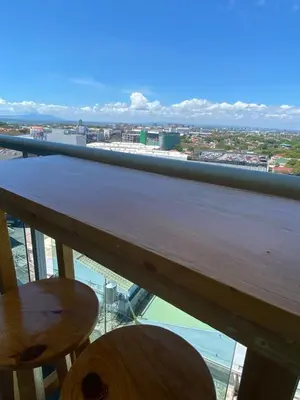 a balcony with a view of the ocean and buildings at Amethyst Suites Azure in Manila