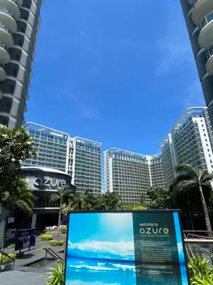 a sign in front of a large building at Amethyst Suites Azure in Manila